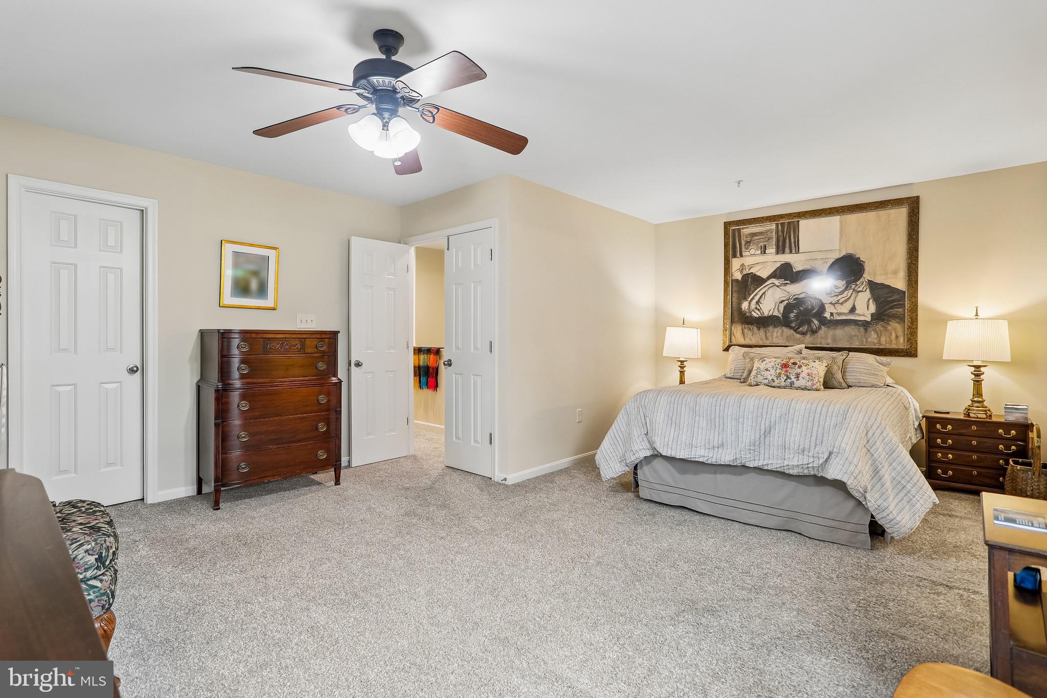 1520 Laurel Wood Way Frederick, MD 21701 - Photo 18 of 30 a spacious bedroom with a bed and a chandelier
