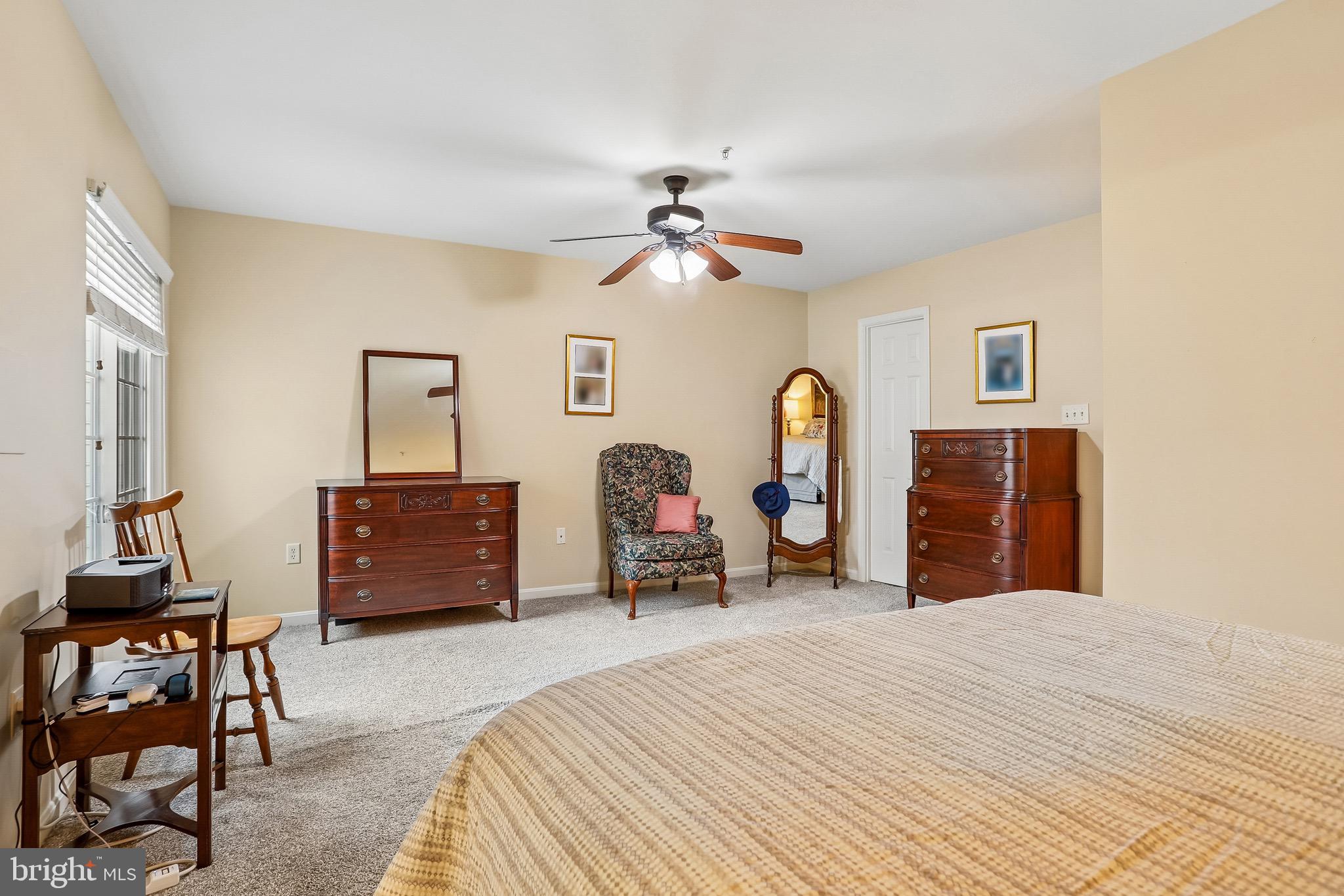 1520 Laurel Wood Way Frederick, MD 21701 - Photo 20 of 30 a bedroom with a bed and a chandelier