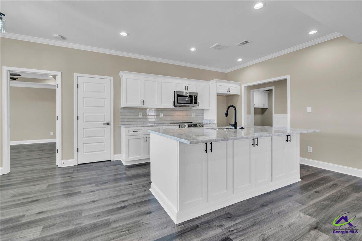 103 Early Drive Byron, GA 31008 - Photo 13 of 56 a kitchen with white cabinets and stainless steel appliances