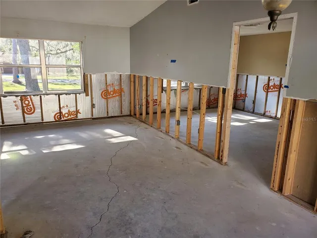 a view of a hallway with entryway and staircase