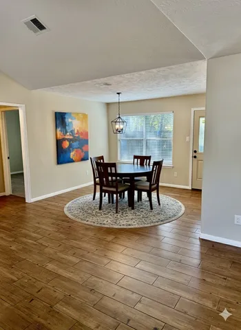 an empty room with windows and ceiling fan