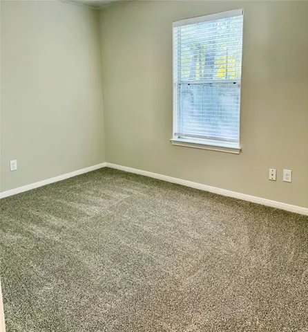 a kitchen with stainless steel appliances granite countertop a stove a sink and white cabinets