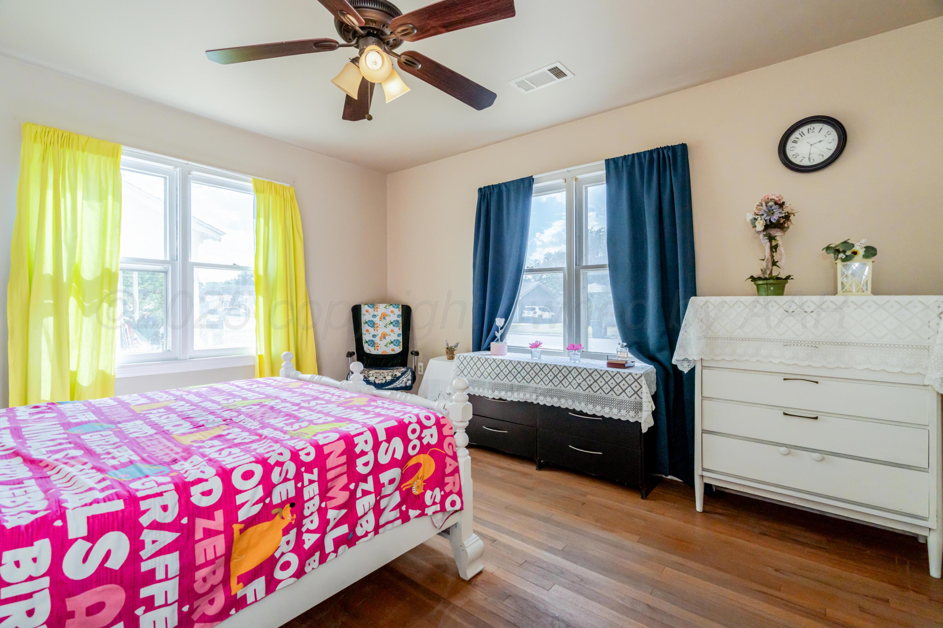 4205 South Jackson Street Amarillo, TX 79110 - Photo 12 of 22 a bedroom with a bed and window