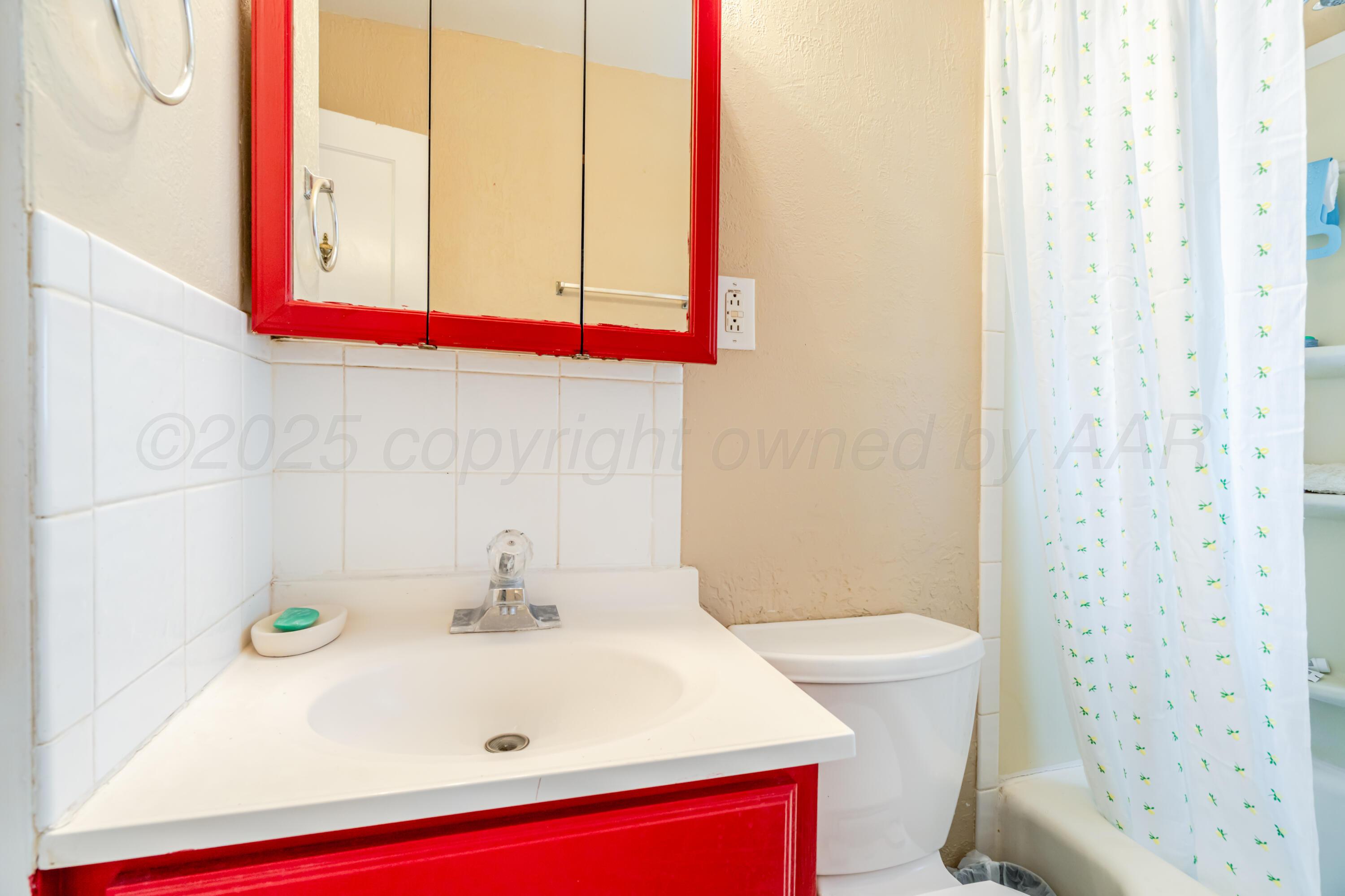 4205 South Jackson Street Amarillo, TX 79110 - Photo 14 of 22 a bathroom with a sink and a toilet