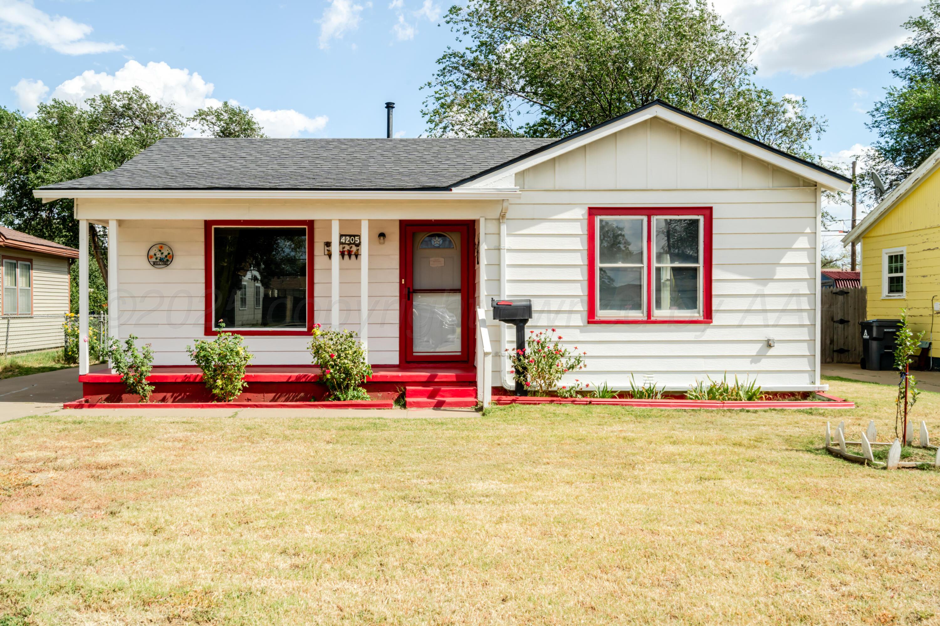 4205 South Jackson Street Amarillo, TX 79110 - Photo 3 of 22 a view of a house with floor to ceiling windows and yard