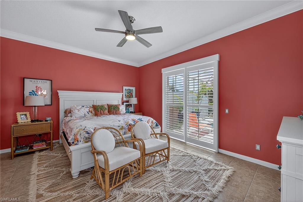 4013 Trinidad Way Naples, FL 34119 - Photo 13 of 35 a bedroom with a bed and a chandelier