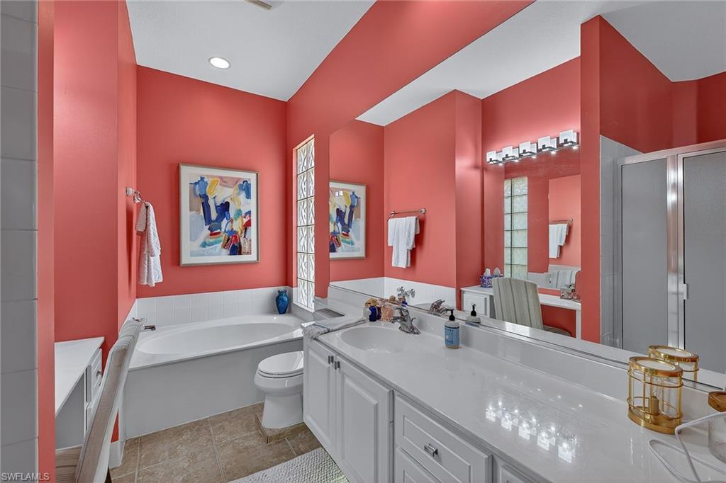 4013 Trinidad Way Naples, FL 34119 - Photo 15 of 35 a bathroom with a double vanity sink and a mirror