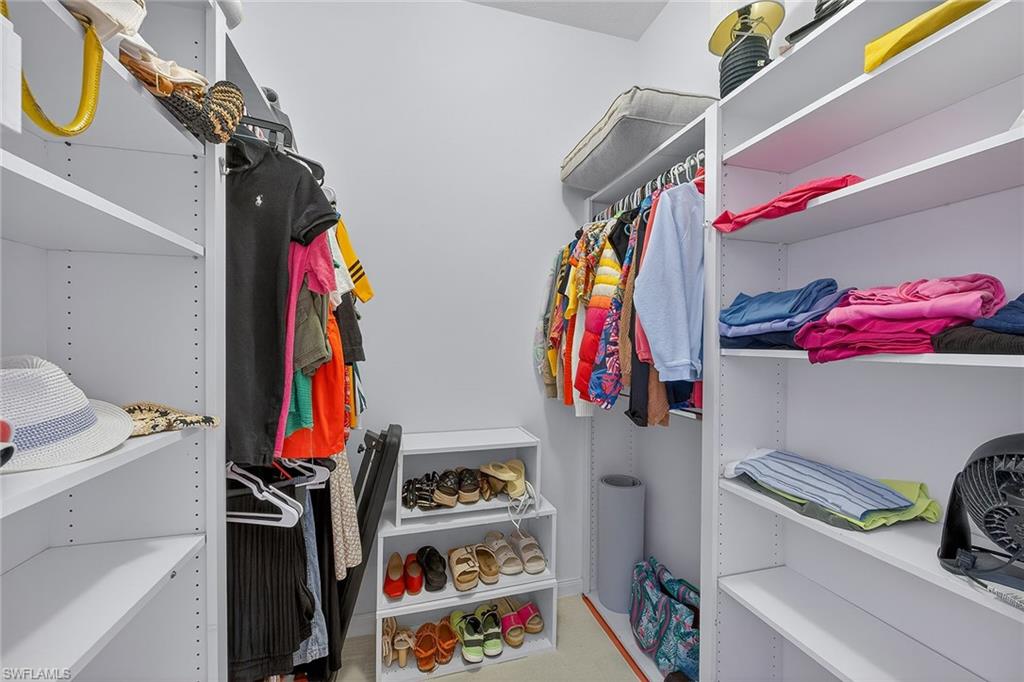 4013 Trinidad Way Naples, FL 34119 - Photo 16 of 35 a view of walk in closet with clothes and shoes
