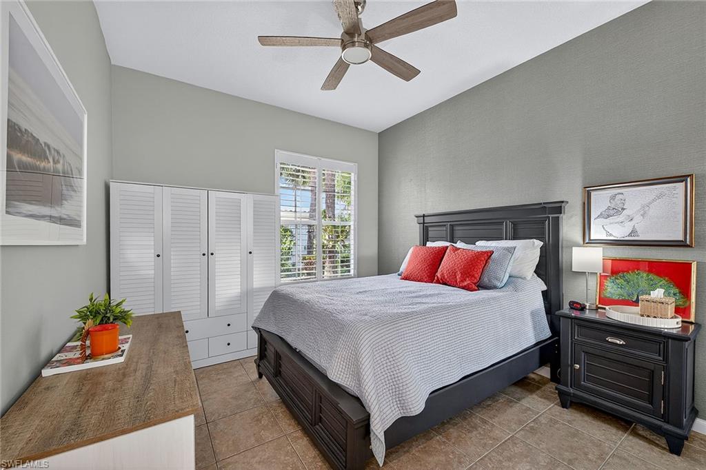4013 Trinidad Way Naples, FL 34119 - Photo 17 of 35 a bedroom with a bed and a flat screen tv