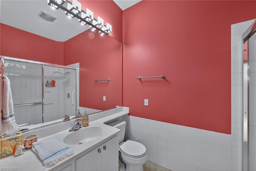 4013 Trinidad Way Naples, FL 34119 - Photo 18 of 35 a bathroom with a sink vanity granite and toilet
