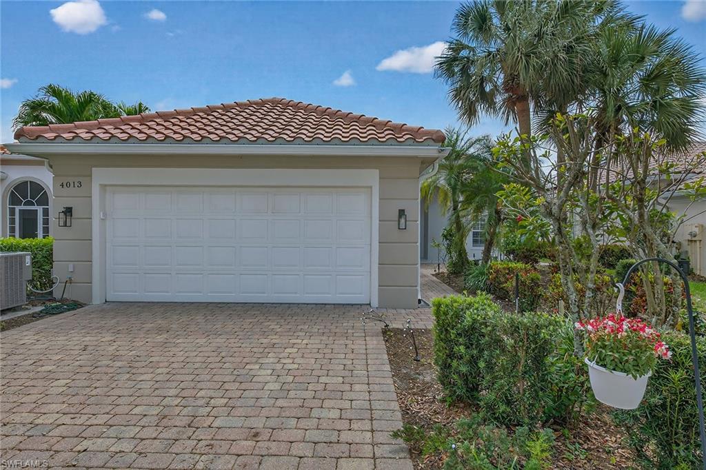 4013 Trinidad Way Naples, FL 34119 - Photo 2 of 35 a front view of a house with a garage