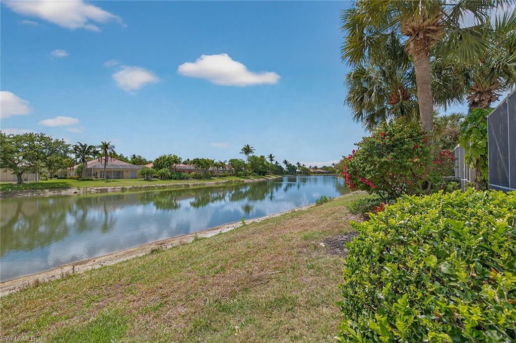 4013 Trinidad Way Naples, FL 34119 - Photo 29 of 35 a view of a lake in between two and trees