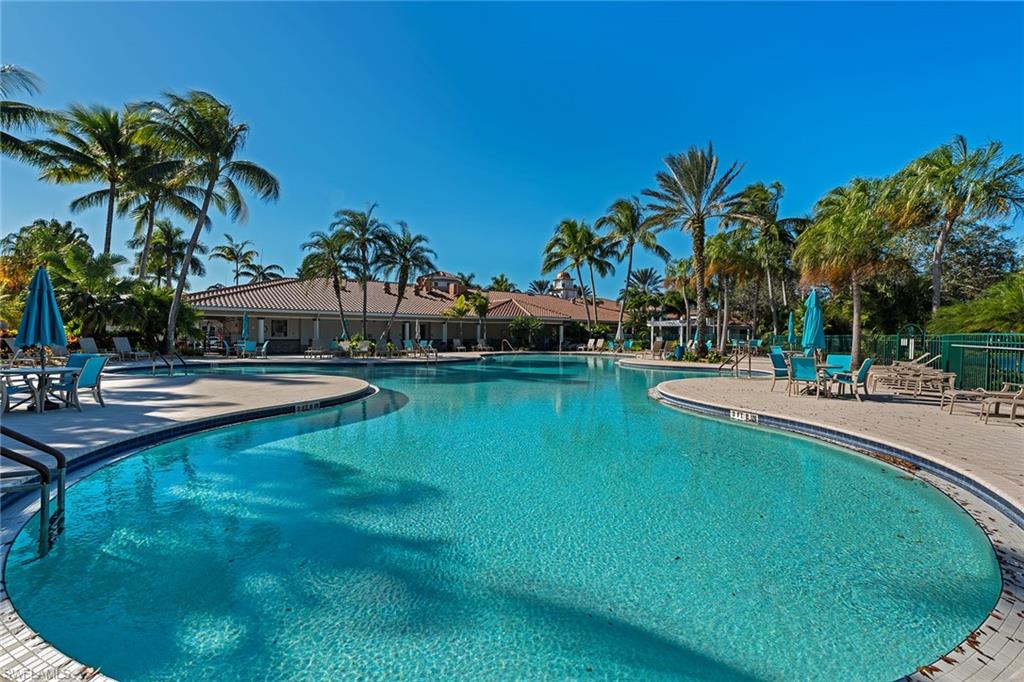 4013 Trinidad Way Naples, FL 34119 - Photo 33 of 35 a view of a swimming pool with a garden