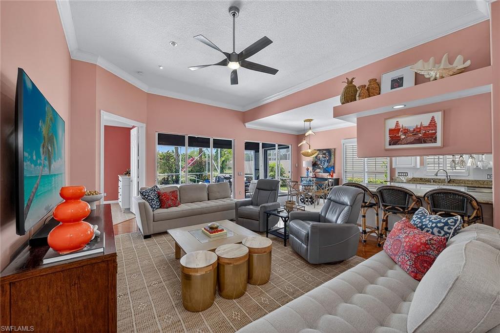 4013 Trinidad Way Naples, FL 34119 - Photo 5 of 35 a living room with furniture a window and a flat screen tv