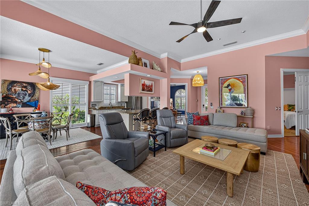 4013 Trinidad Way Naples, FL 34119 - Photo 6 of 35 a living room with furniture and a chandelier