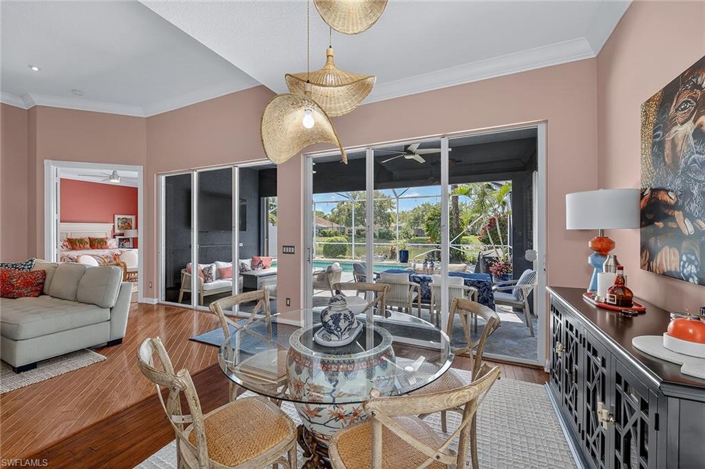 4013 Trinidad Way Naples, FL 34119 - Photo 7 of 35 a view of a dining room with furniture wooden floor and chandelier