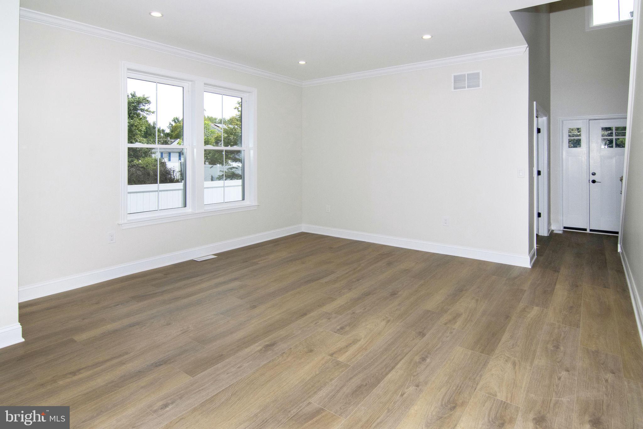 903 Mercer Street Cherry Hill, NJ 08002 - Photo 11 of 58 an empty room with wooden floor and windows