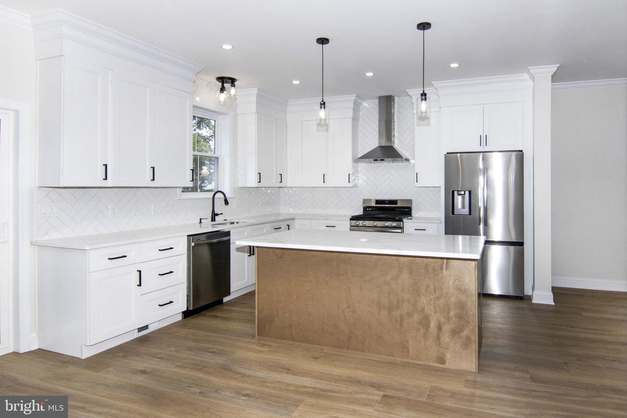 903 Mercer Street Cherry Hill, NJ 08002 - Photo 12 of 58 a kitchen with stainless steel appliances granite countertop a stove a sink and a refrigerator