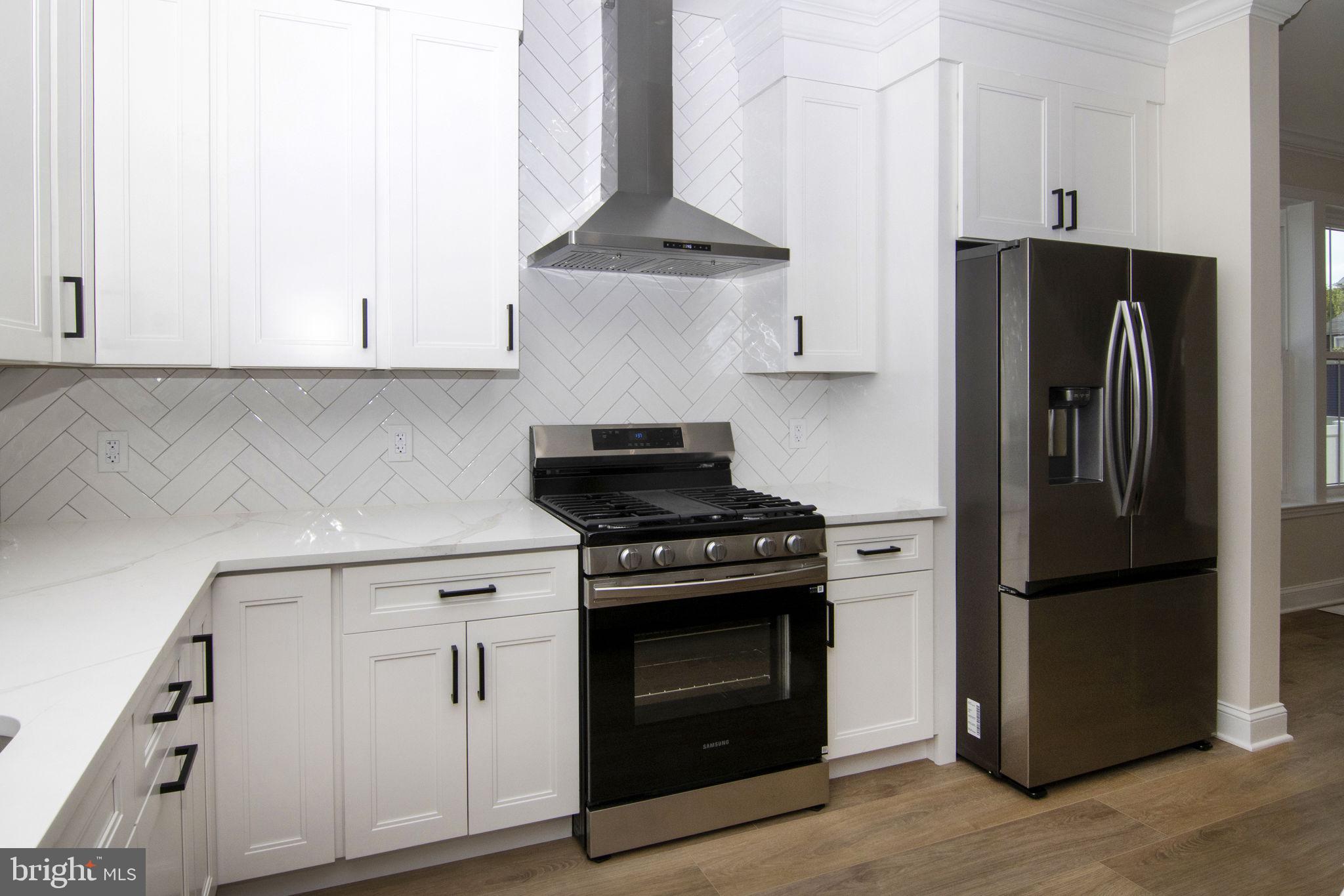 903 Mercer Street Cherry Hill, NJ 08002 - Photo 15 of 58 a kitchen with a stove and a refrigerator