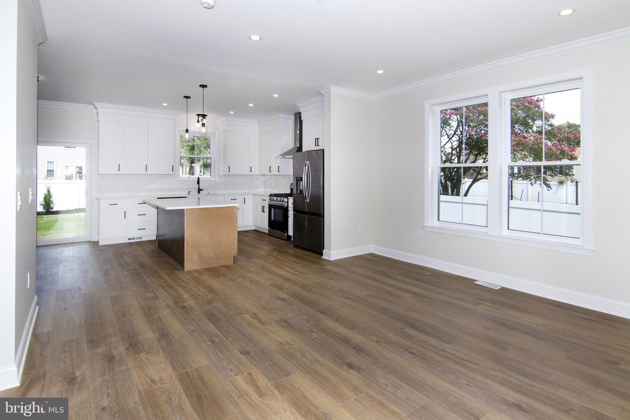 903 Mercer Street Cherry Hill, NJ 08002 - Photo 9 of 58 a living room with stainless steel appliances kitchen island hardwood floor and a large window