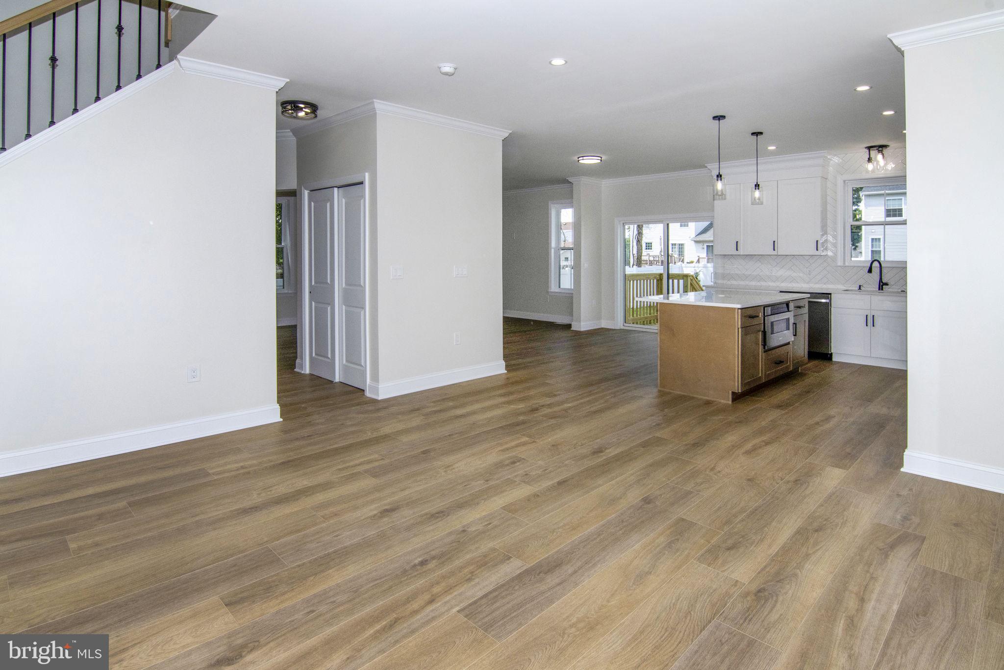 903 Mercer Street Cherry Hill, NJ 08002 - Photo 10 of 58 a view of kitchen with kitchen island wooden floor center island and stainless steel appliances