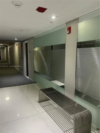 a view of an empty room with a floor to ceiling window