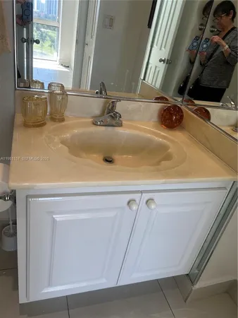 a kitchen that has a sink and a refrigerator in it