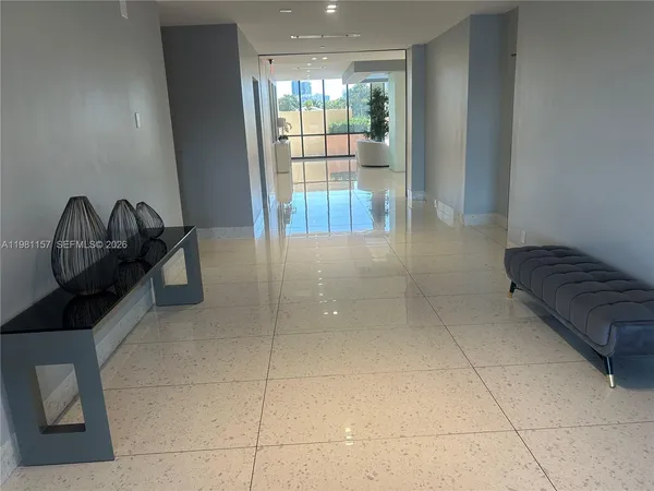 a lobby with furniture and glass door