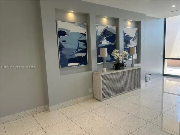 a living room with furniture a potted plant and a fireplace