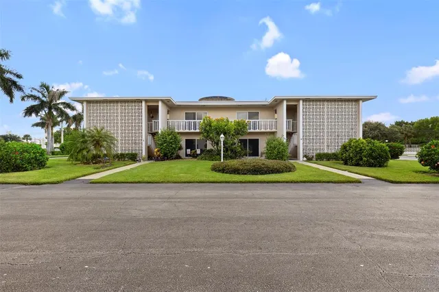 a view of a house with a backyard and a yard