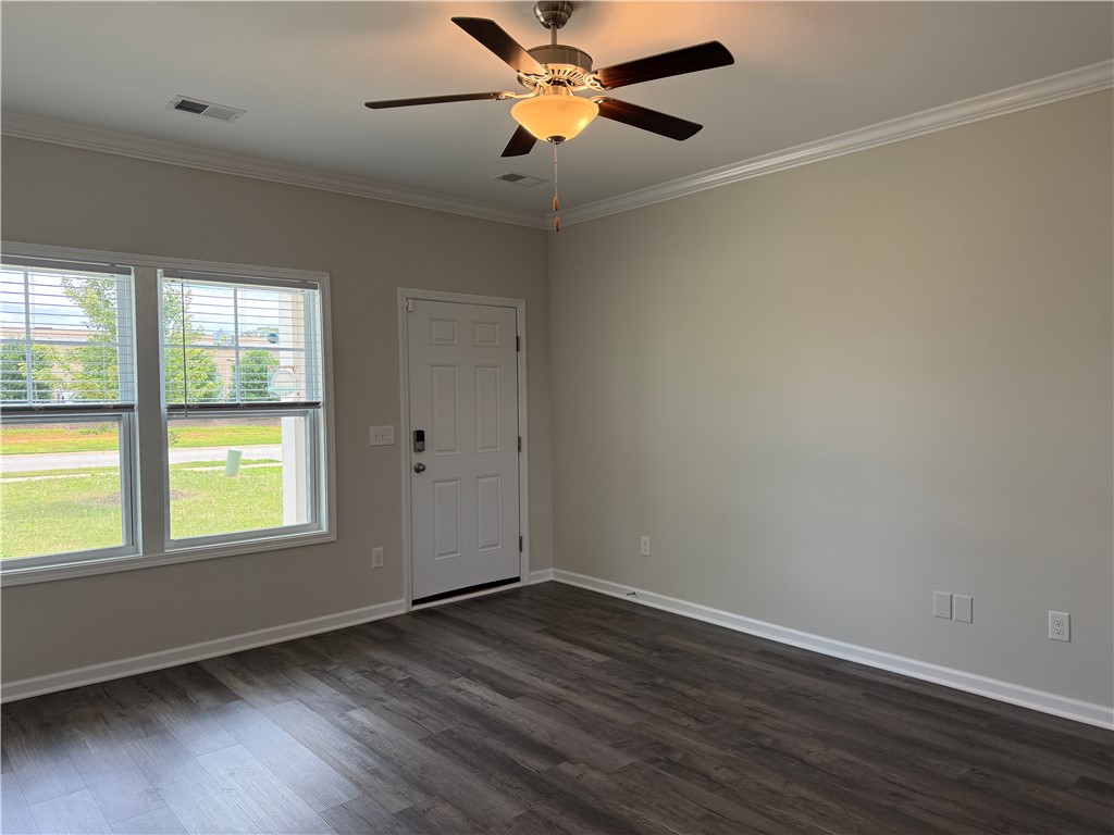 117 Weaver Way Pendleton, SC 29670 - Photo 3 of 19 A well-proportioned room features durable wood-look flooring and crown molding, creating an inviting atmosphere.