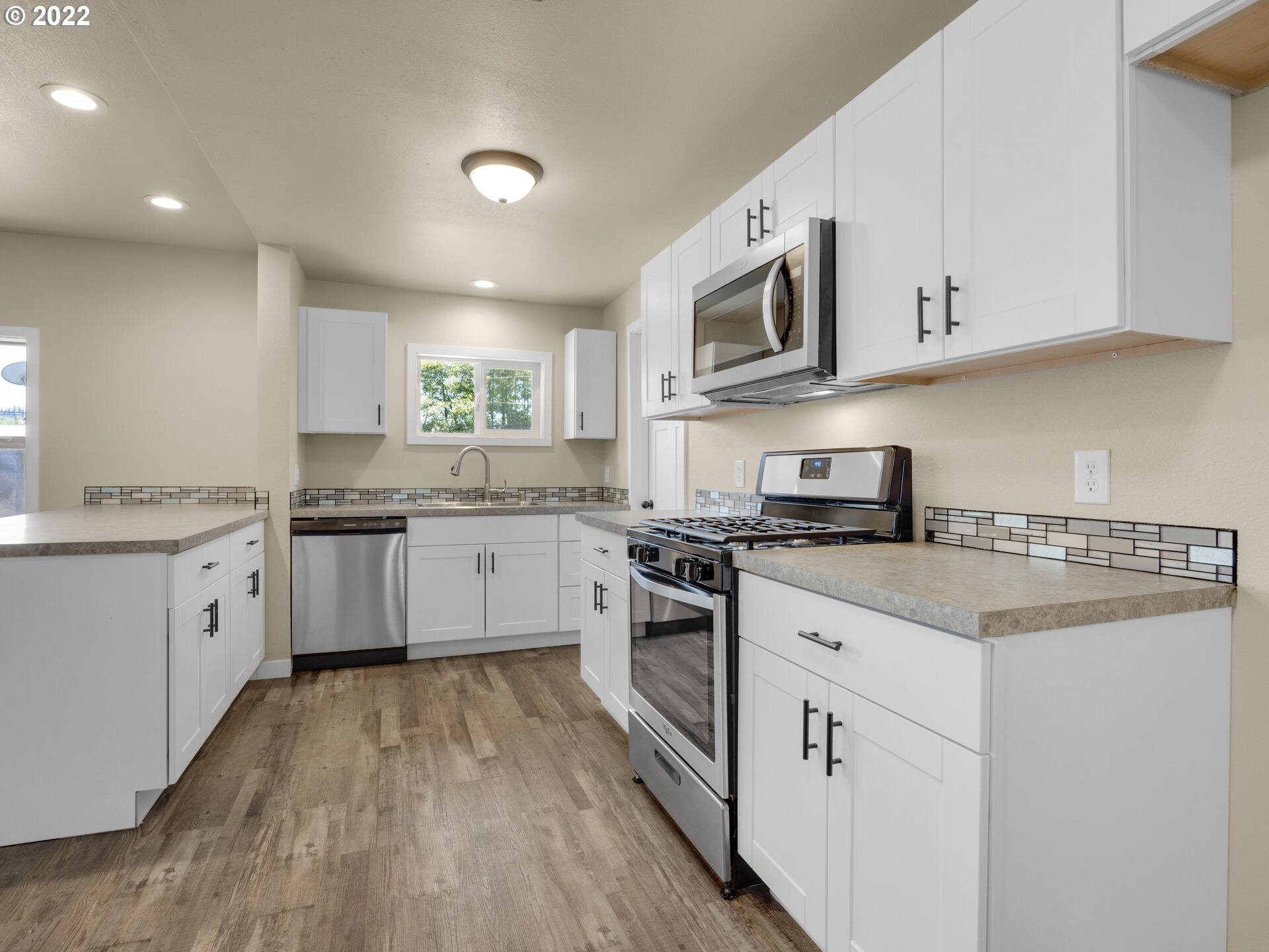 92356 E Road Astoria, OR 97103 - Photo 7 of 31 a kitchen with stainless steel appliances granite countertop a stove a sink dishwasher and a refrigerator