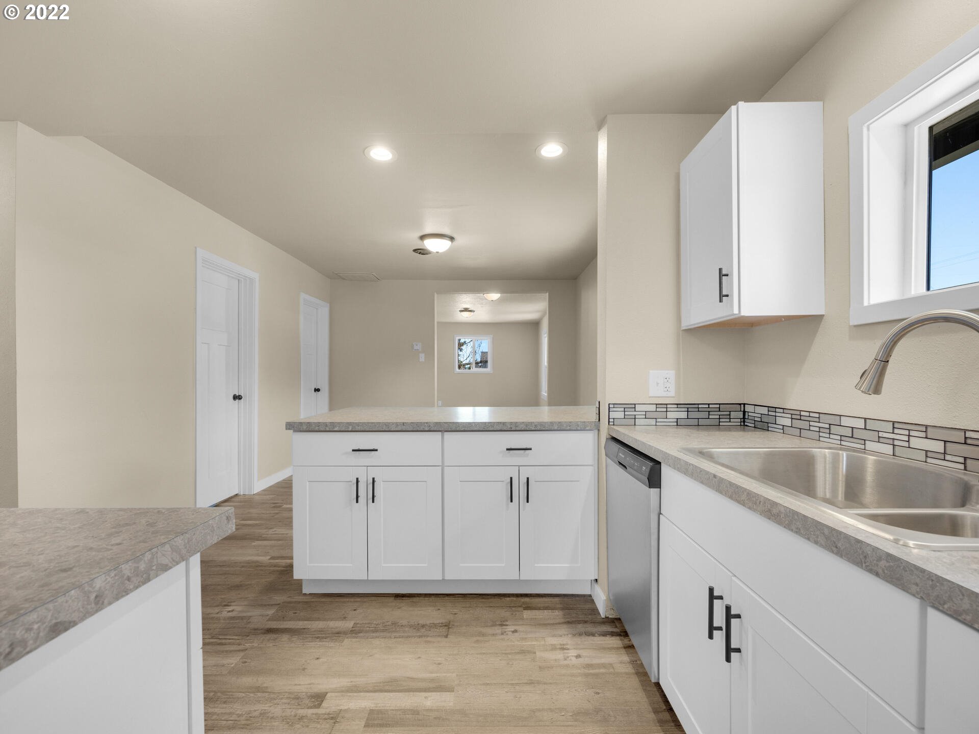 92356 E Road Astoria, OR 97103 - Photo 8 of 31 a kitchen with granite countertop white cabinets and a sink