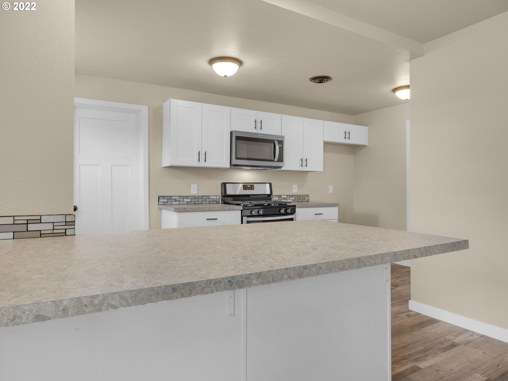 92356 E Road Astoria, OR 97103 - Photo 10 of 31 a kitchen with a stove a sink and a refrigerator
