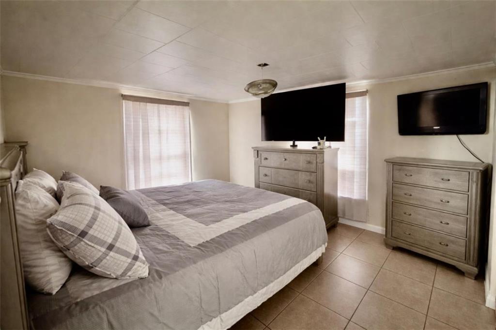 3911 Blackstock Road Talmo, GA 30575 - Photo 11 of 17 a bedroom with a bed a television and a couch