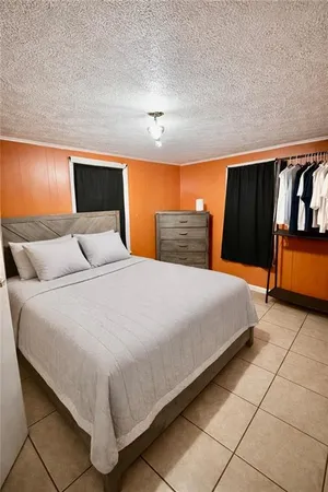 a bedroom with a bed and night stand