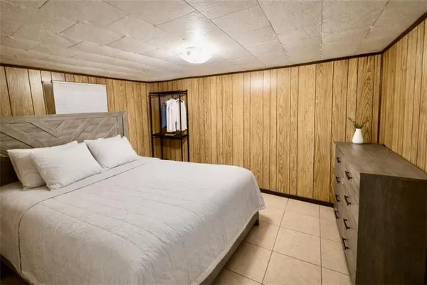 a bedroom with a large bed and a dresser
