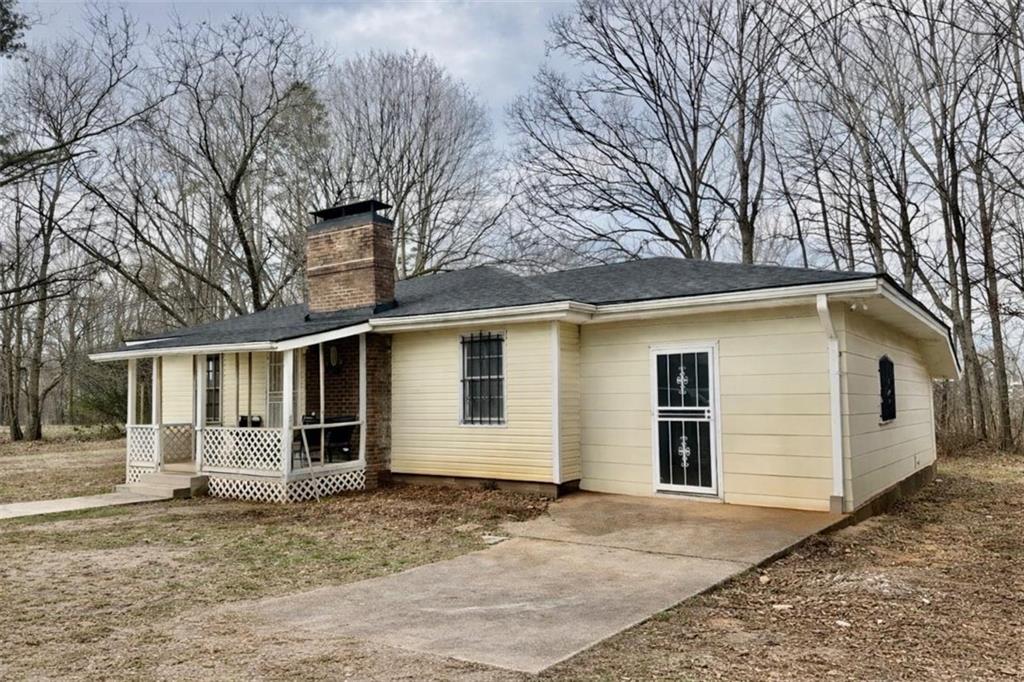 3911 Blackstock Road Talmo, GA 30575 - Photo 3 of 17 a front view of a house with a yard and garage