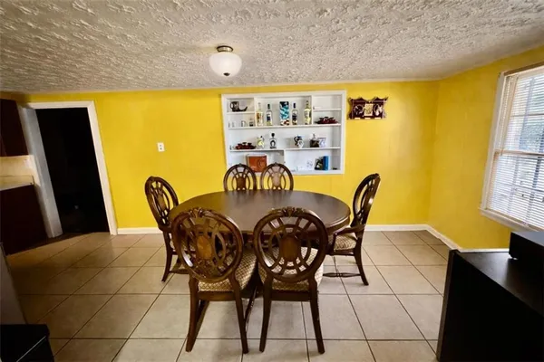 a view of a dining room with furniture and a window
