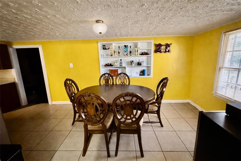 3911 Blackstock Road Talmo, GA 30575 - Photo 7 of 17 a view of a dining room with furniture and a window