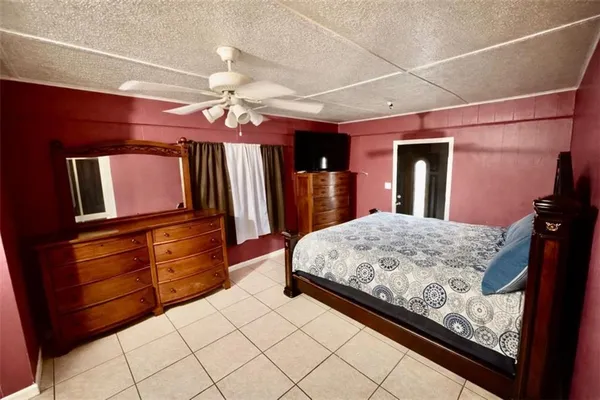 a living room with kitchen island granite countertop furniture and a flat screen tv