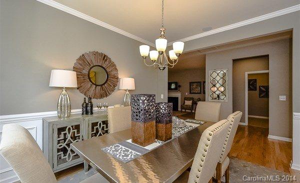4282 Perth Road, Unit 315 Indian Land, SC 29707 - Photo 3 of 12 a view of a dining room with furniture wooden floor and chandelier