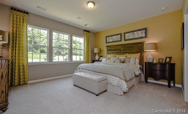 4282 Perth Road, Unit 315 Indian Land, SC 29707 - Photo 8 of 12 a bedroom with a bed and a night stand