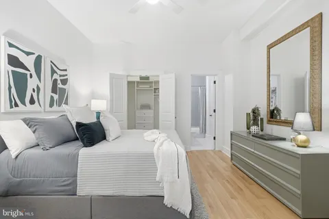 a bedroom with a bed and a chandelier