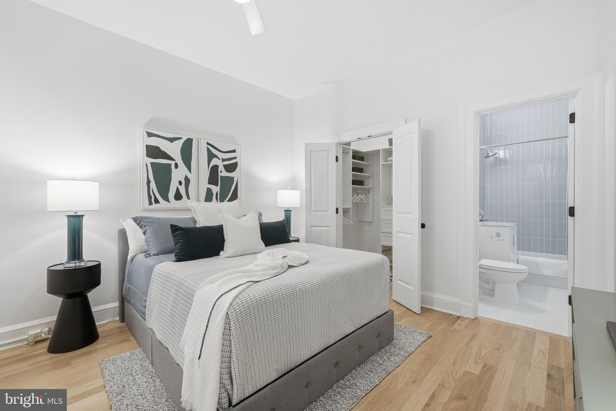 1613 Harvard Street Northwest, Unit 102 Washington, DC 20009 - Photo 14 of 21 a bedroom with a bed and a view of bathroom