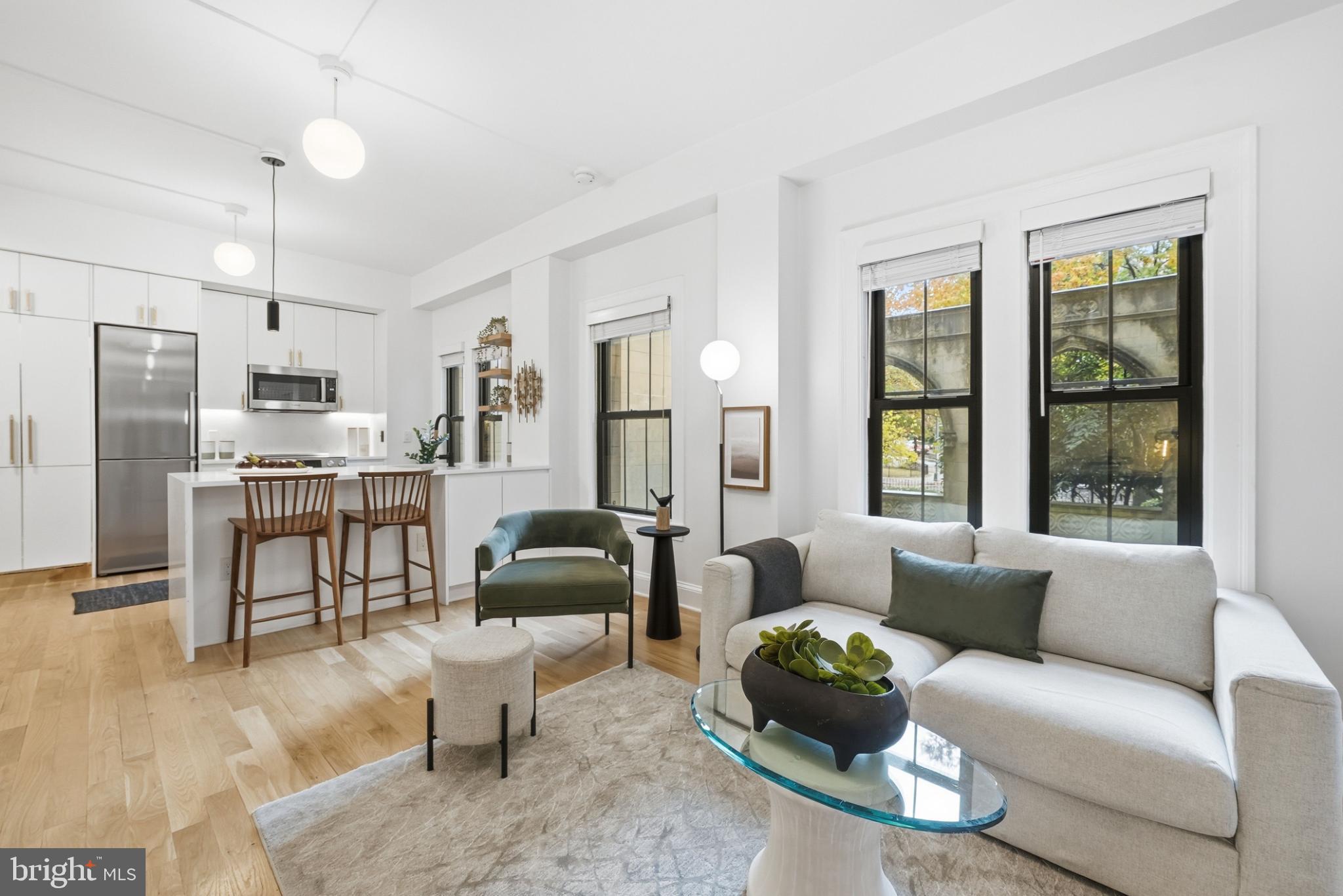 1613 Harvard Street Northwest, Unit 102 Washington, DC 20009 - Photo 3 of 21 a living room with furniture and a large window