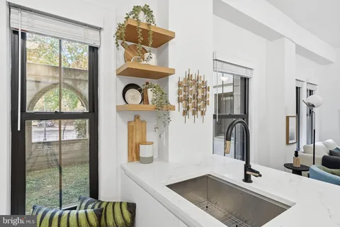 a living room with furniture and view of kitchen