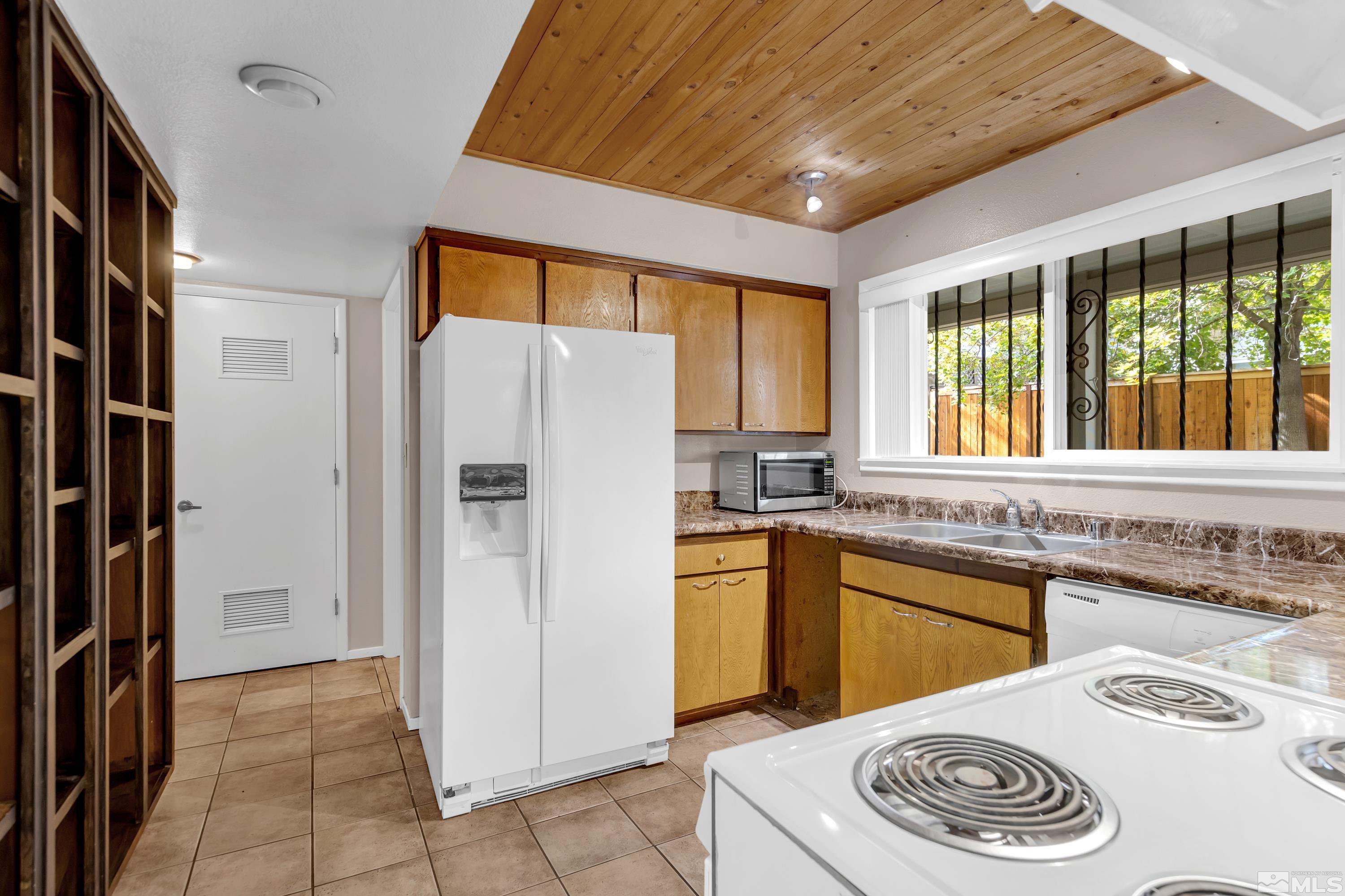 4001 Ruth Court Reno, NV 89509 - Photo 15 of 40 a kitchen with a sink a refrigerator and cabinets