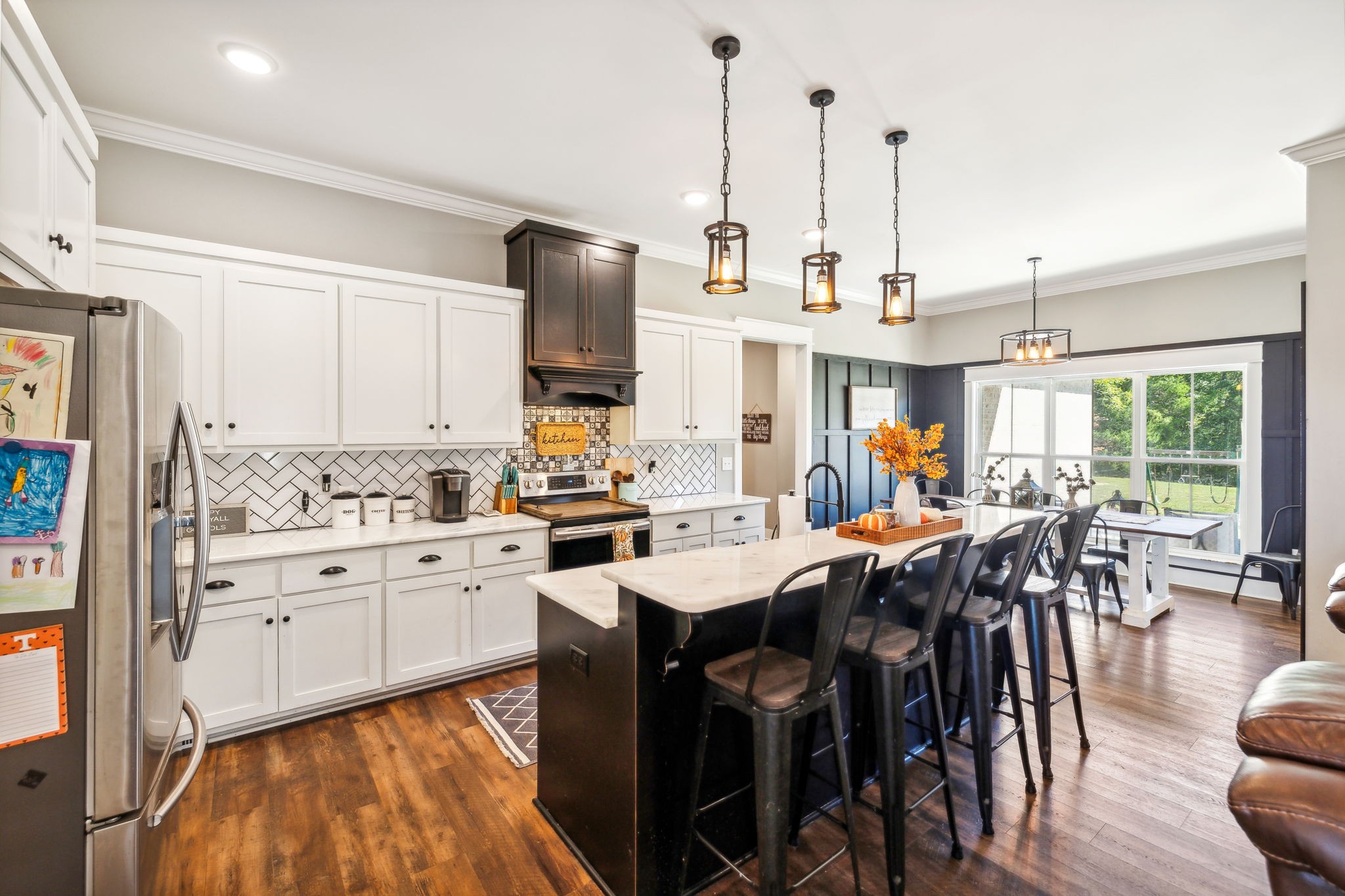 1338 Norton Road Manchester, TN 37355 - Photo 12 of 55 a kitchen with stainless steel appliances a stove a sink a center island a table and chairs