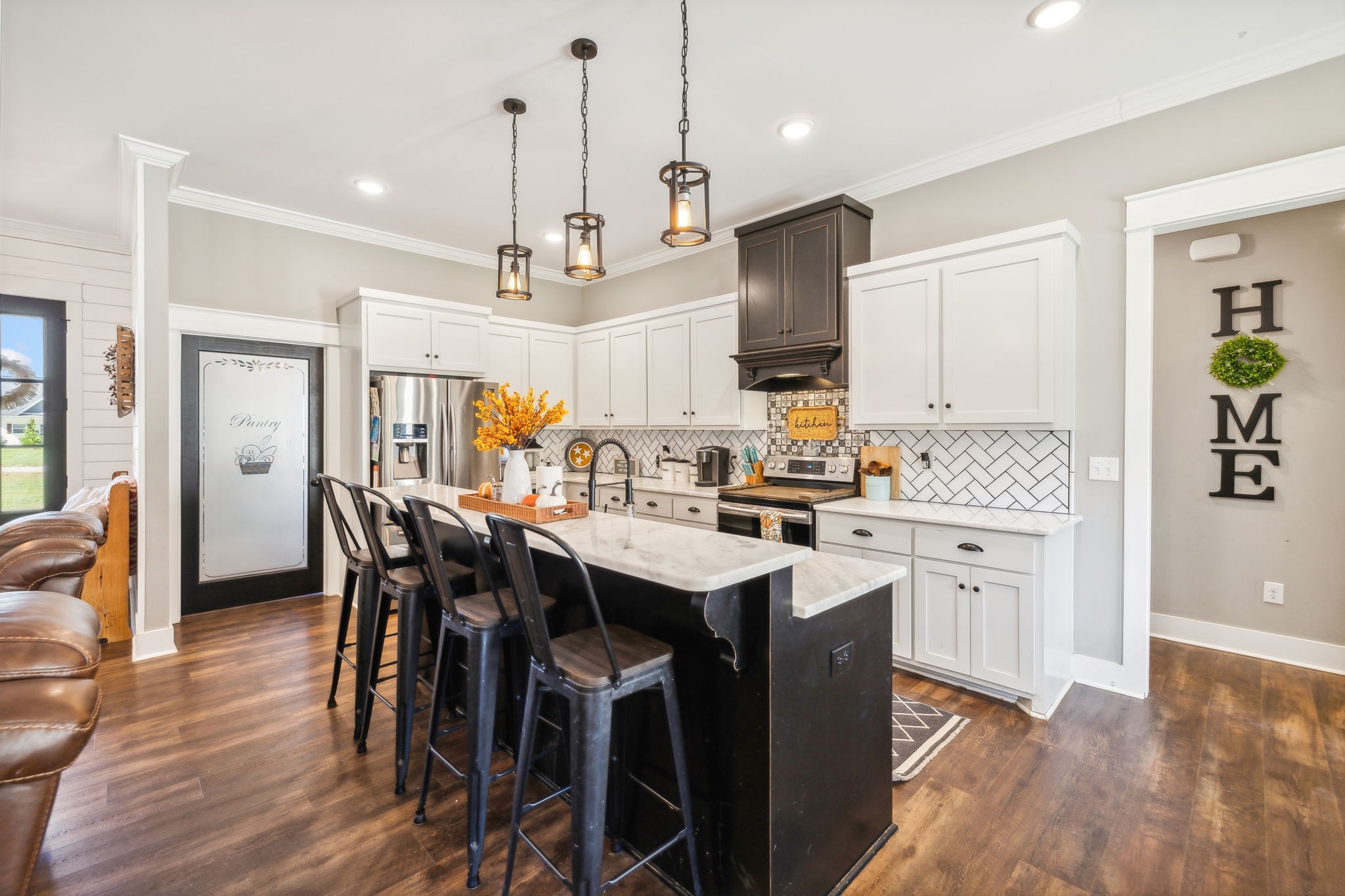 1338 Norton Road Manchester, TN 37355 - Photo 14 of 55 a kitchen with stainless steel appliances kitchen island granite countertop a wooden floor and white cabinets